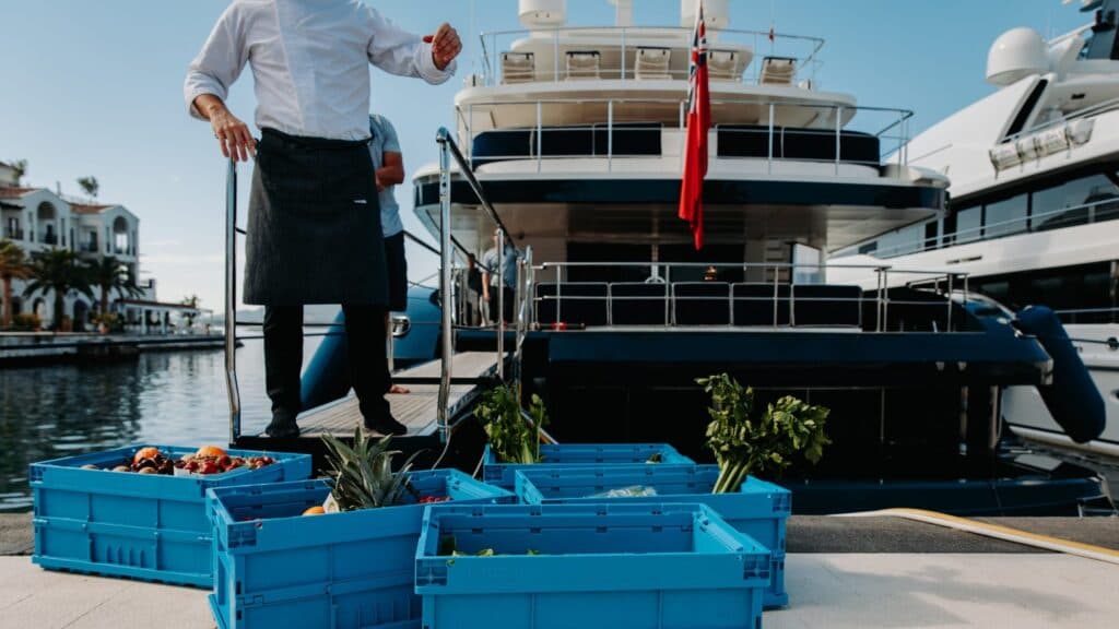 Crates of provisions beside a yacht